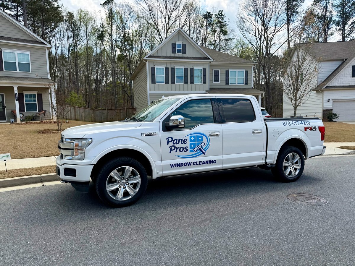 White Pane Pros service truck parked in suburban residential street with houses in background